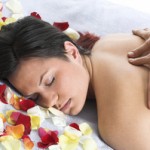 Woman getting a back massage in front of the white background